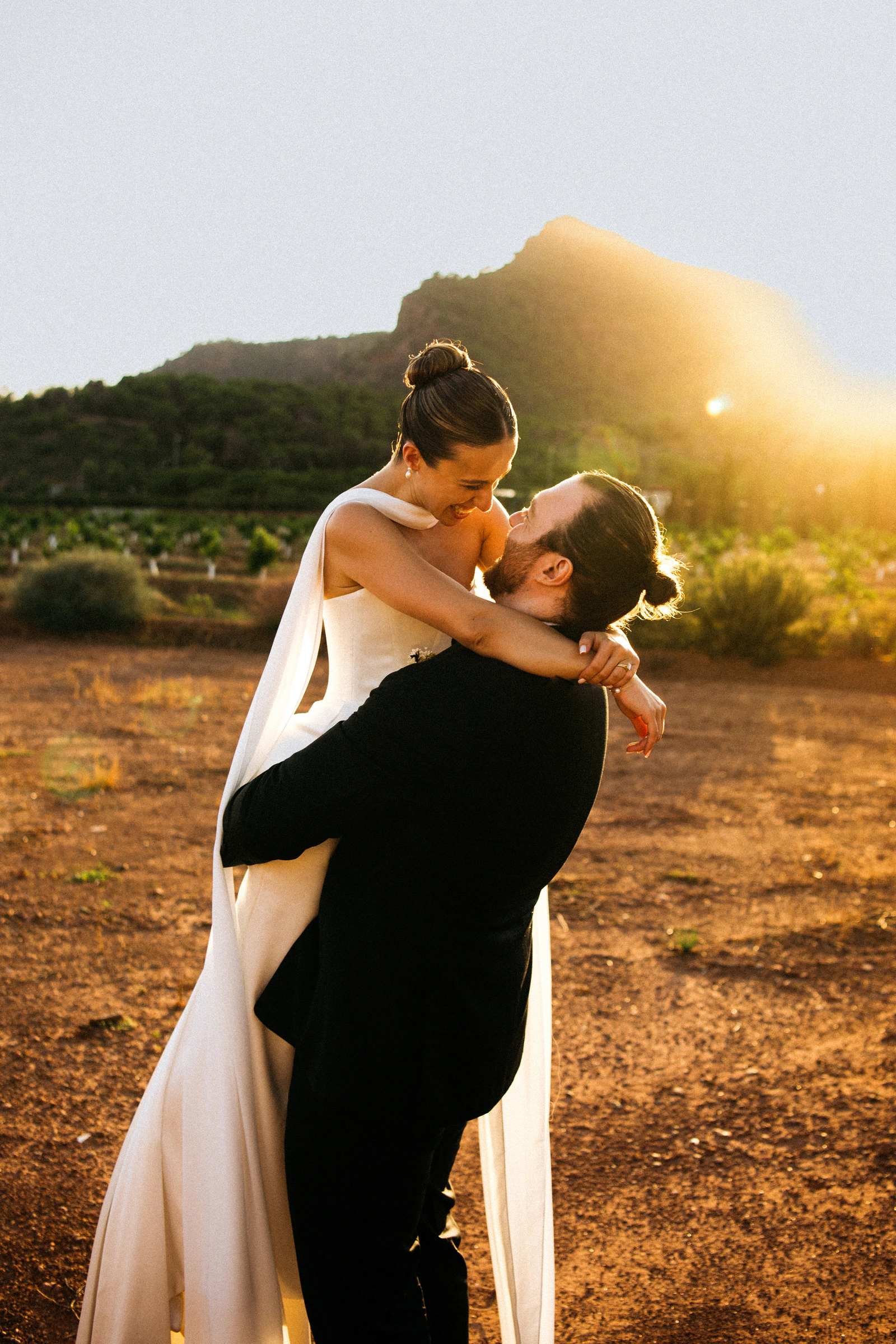 Ada and Liam embracing in the evening light at their Valencia wedding