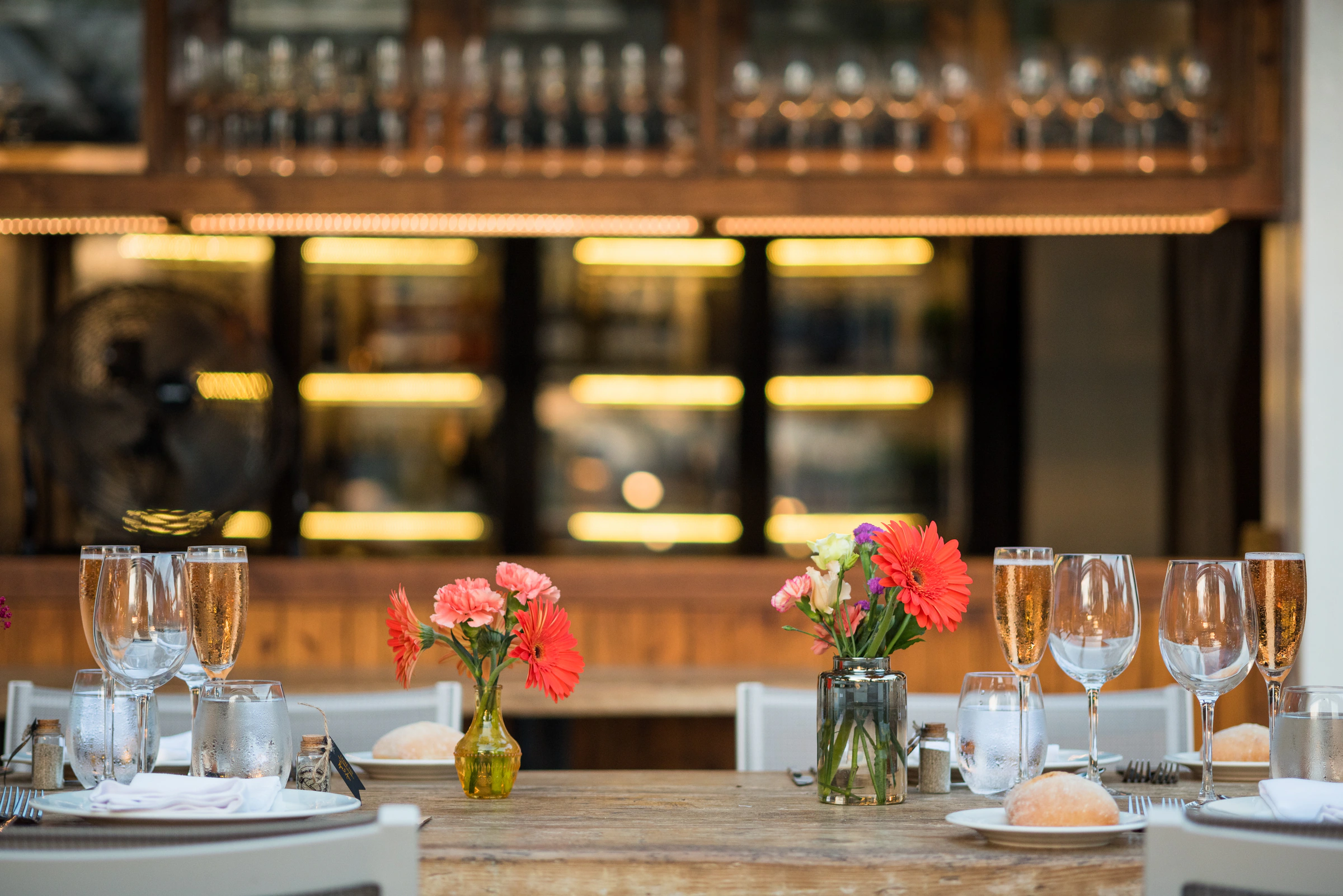 Colourful flowers and glassware prepared beside the Mediterranean in Ibiza
