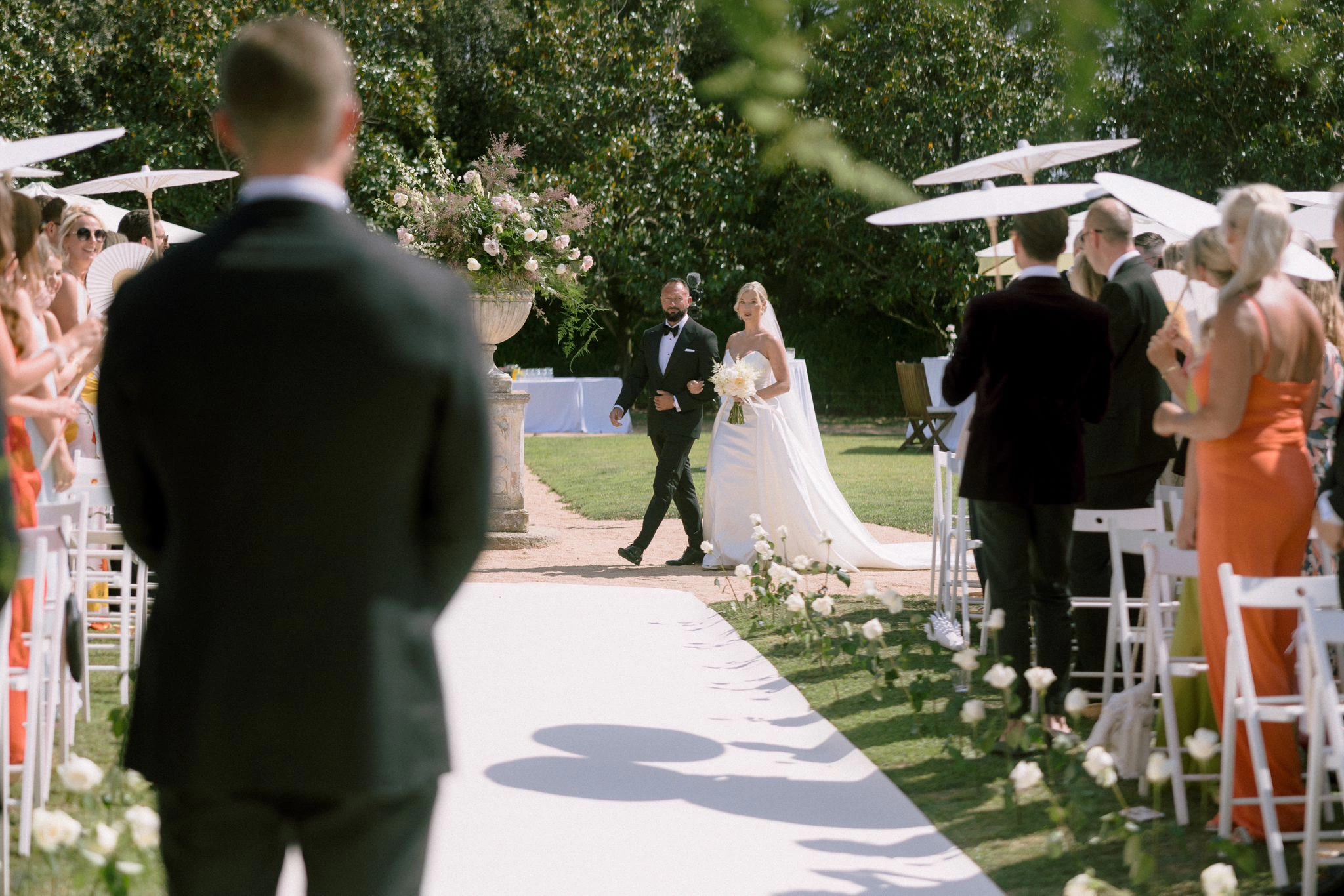 Darrelle and Ben walking from their garden wedding ceremony in Barcelona