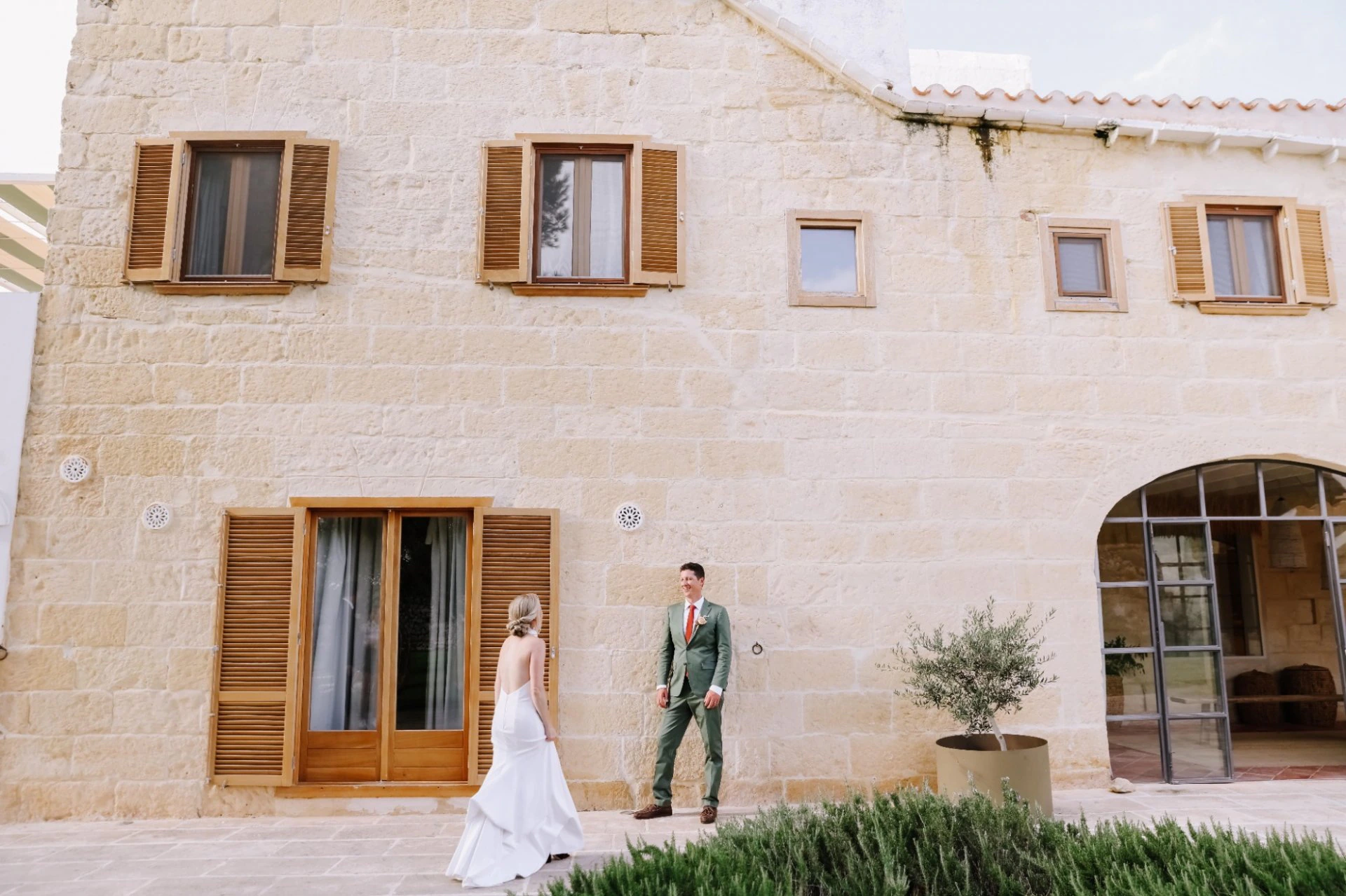 Newlyweds outside a stone wedding venue in Spain
