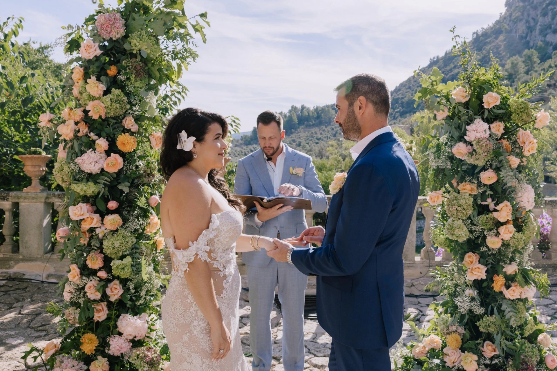 Outdoor ceremony framed by flowers in a Spanish wedding setting
