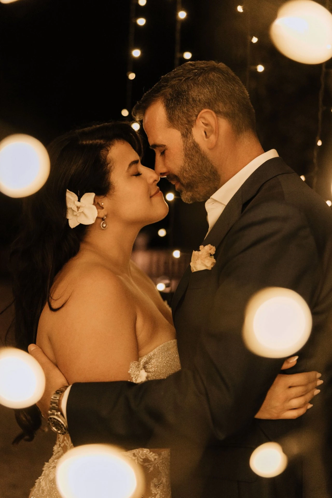 Newlyweds celebrating beneath evening lights