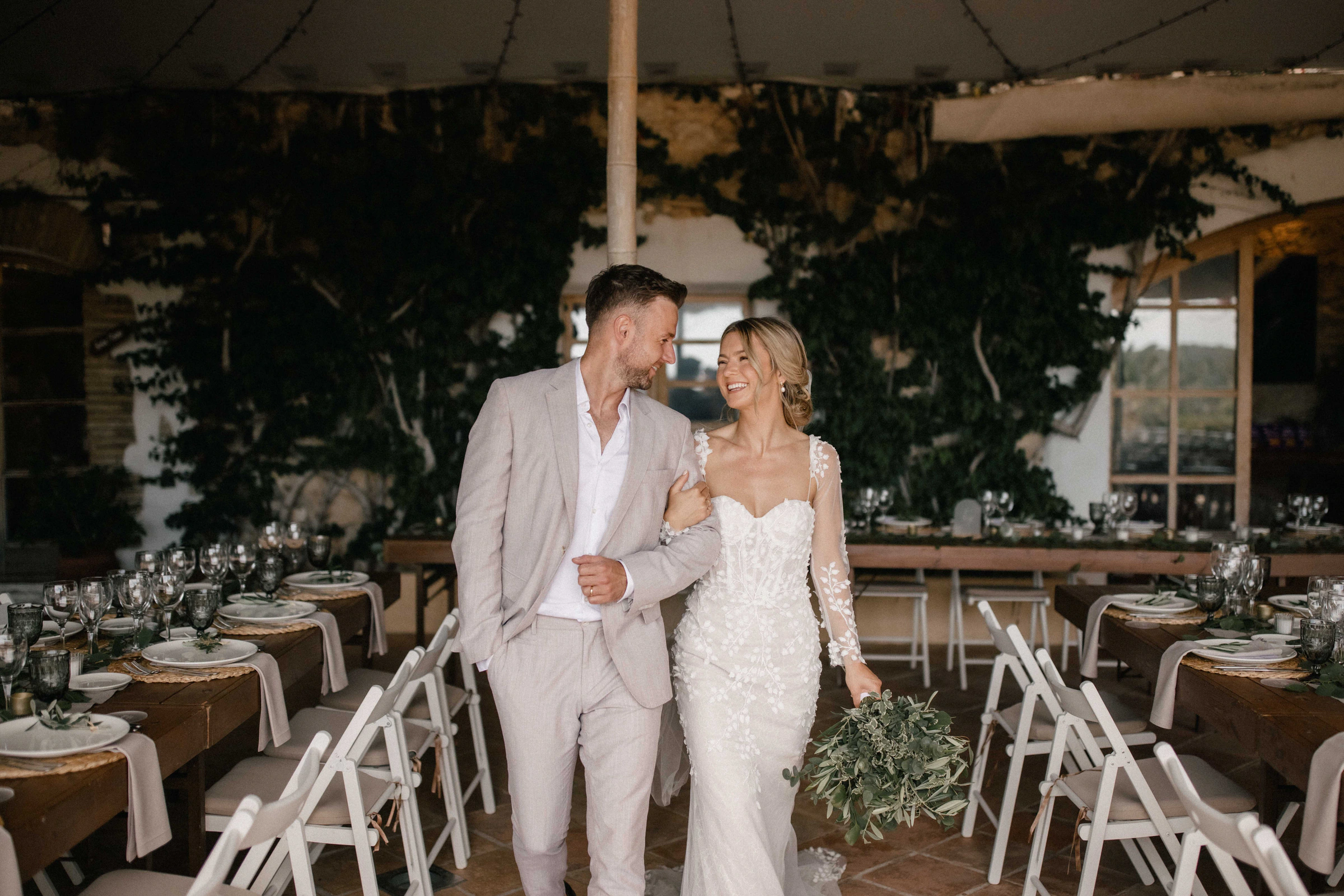 Samantha and Barry beside their reception tables at a finca in Sitges