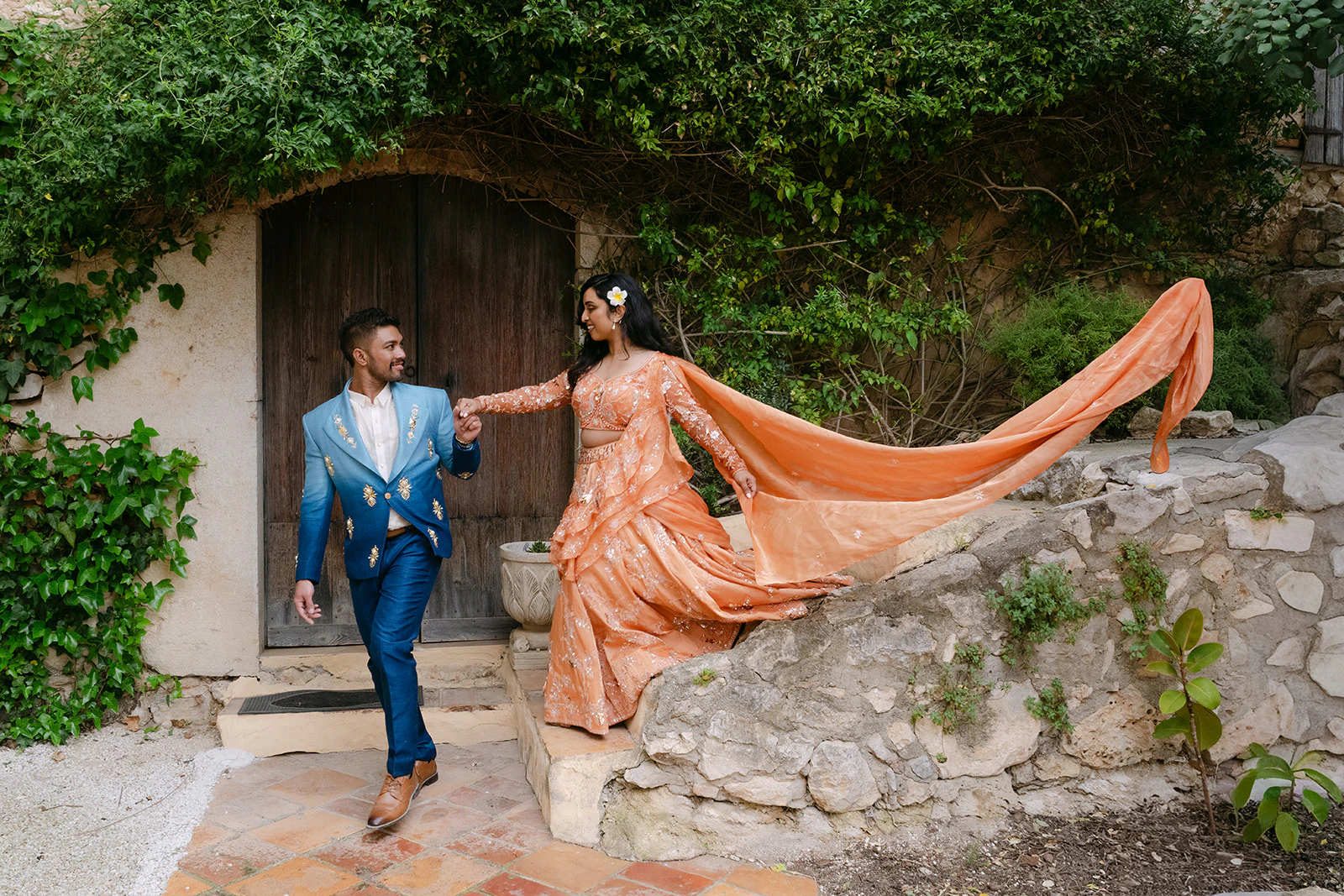 Samidha and Jarryd together in peach and blue wedding attire during their two-day Indian wedding celebration in Spain